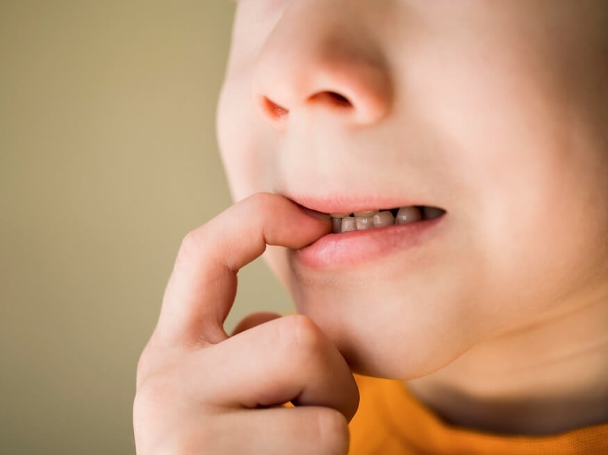 Little boy hispanic kid wearing casual clothes looking stressed and nervous  with hands on mouth biting nails. anxiety problem Stock Photo - Alamy