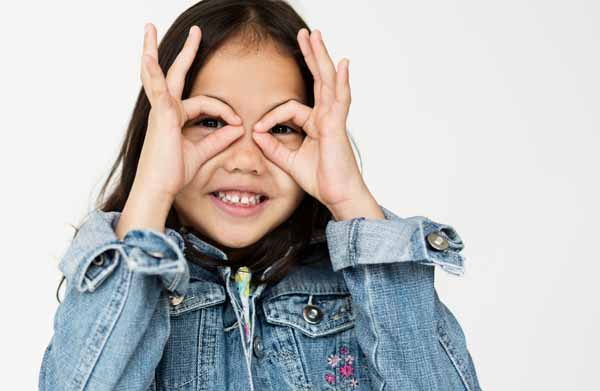 A kid pointing finger towards the eyes