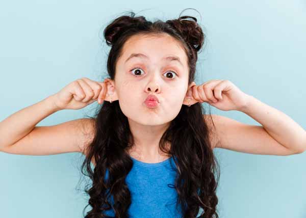 A small girl showing ears