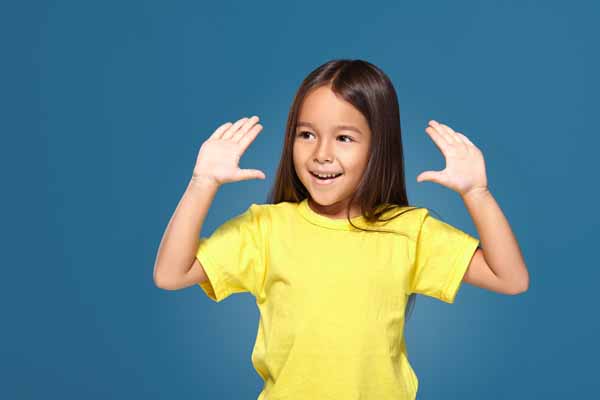 A little girl showing her hands with smile