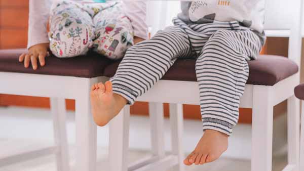 A little girl showing her legs with smile
